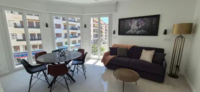 a living room with a couch and a table at Iconic and bright style in Nice in Nice