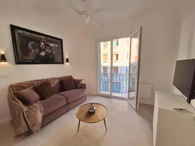a living room with a couch and a table at Iconic and bright style in Nice in Nice