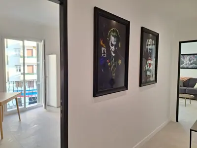a living room with three framed pictures on a wall at Iconic and bright style in Nice in Nice