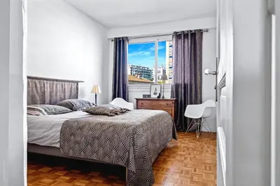 a bedroom with a bed and a window at Amazing Sunset in Nice
