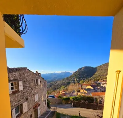 a view from a window of a town with mountains at Plaisirs entre mer et montagne in Aspremont