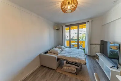 a bedroom with a bed and a flat screen tv at Studio rénové à deux pas de la mer et commerces in Cagnes-sur-Mer