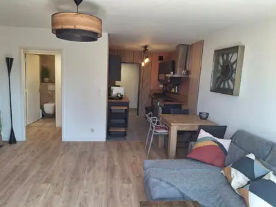 a living room with a couch and a table at Lovely apartment with private garden and a swimming-pool in Nice