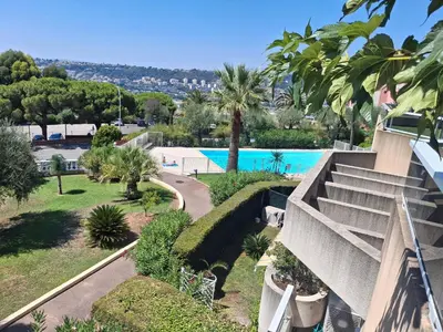 a view of a resort with a swimming pool at Lovely apartment with private garden and a swimming-pool in Nice