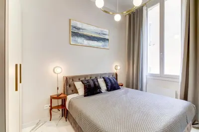 a bedroom with a bed and a window at Pearl of Nice in Nice
