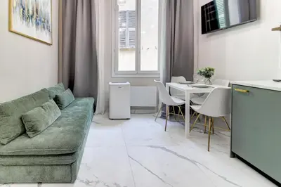 a living room with a couch and a table at Pearl of Nice in Nice