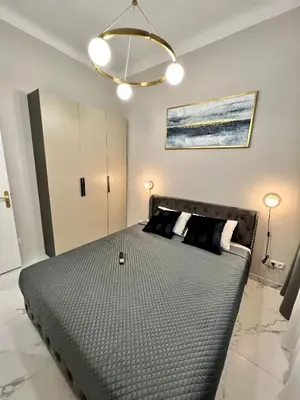a bedroom with a large bed with black pillows at Pearl of Nice in Nice