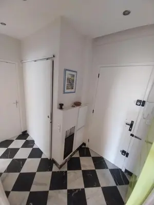 a room with two white doors and a checkered floor at Modern Appart Nice, proche Gare Riquier in Nice