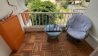 a balcony with two chairs and a table on a floor at Modern Appart Nice, proche Gare Riquier in Nice