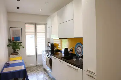a kitchen with white cabinets and a stove top oven at Modern Appart Nice, proche Gare Riquier in Nice