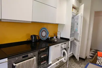 a kitchen with white cabinets and a dishwasher at Modern Appart Nice, proche Gare Riquier in Nice