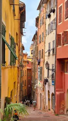 a view of an alley in a city with buildings at Spacious apartment in Cimiez in Nice