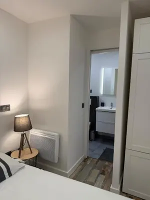 a bedroom with a bed and a bathroom with a sink at Charmant studio en centre de Nice in Nice