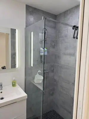 a bathroom with a glass shower and a sink at Charmant studio en centre de Nice in Nice