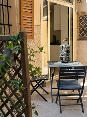 a table and a chair on a patio at Charmant studio en centre de Nice in Nice