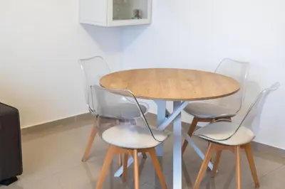 a wooden table with four chairs around it at Azur Stay 3 Start Beach 8 min Tram Airport 5m in Nice