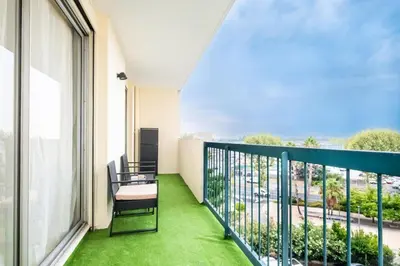 a balcony with a table and chairs and a view at Azur Stay 3 Start Beach 8 min Tram Airport 5m in Nice