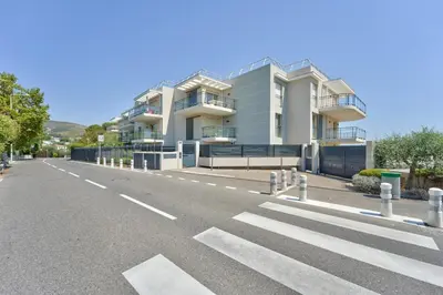 an empty street in front of a large building at Lovely 1BR with garden, private parking & Sea View in Nice