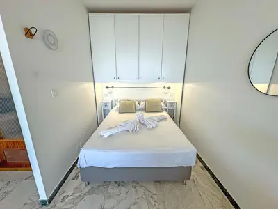 a kitchen with white cabinets and a sink at Riviera Escape Promenade Nice in Nice