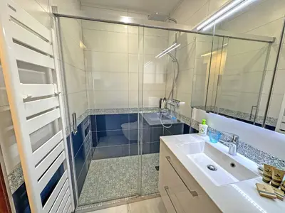 a small bedroom with a bed and a mirror at Riviera Escape Promenade Nice in Nice