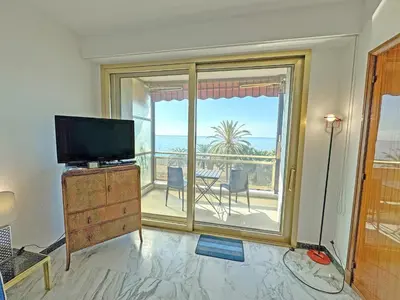 a living room with a tv and a large window at Riviera Escape Promenade Nice in Nice