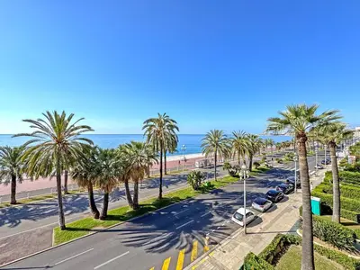 a table and chairs on a balcony with a view of the ocean at Riviera Escape Promenade Nice in Nice