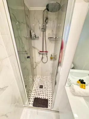 a shower with a glass door in a bathroom at Bright, Central & Stylish 3 Min Walk to the Sea in Nice