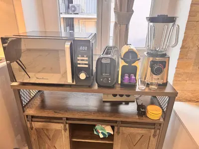 a counter with a microwave and other appliances on it at Bright, Central & Stylish 3 Min Walk to the Sea in Nice
