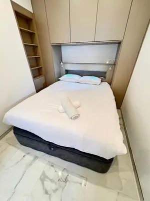 a bed with two towels on it in a room at Bright, Central & Stylish 3 Min Walk to the Sea in Nice