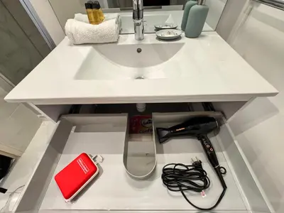 a white counter with a sink andcellaneous items on it at Bright, Central & Stylish 3 Min Walk to the Sea in Nice