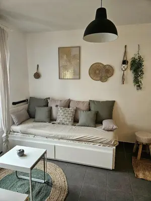 a living room with a couch and a table at Charming studio in Nice