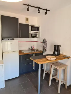 a kitchen with a table and a counter top at Charming studio in Nice