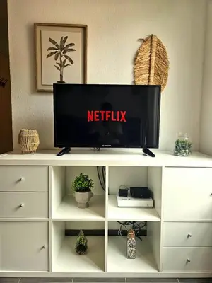 a tv on top of a white entertainment center at Charming studio in Nice