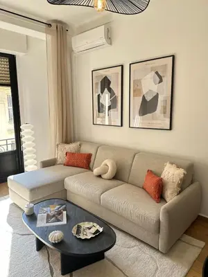a living room with a couch and a table at Chic et confort- Nice- 3 à 5 personnes in Nice