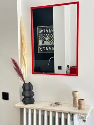 a mirror on a wall above a shelf in a room at Chic et confort- Nice- 3 à 5 personnes in Nice