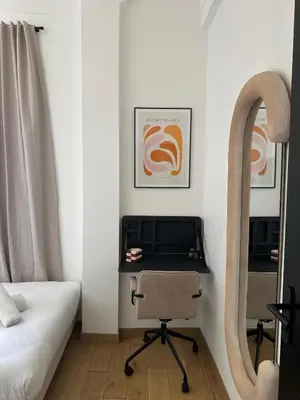 a bedroom with a desk with a chair and a bed at Chic et confort- Nice- 3 à 5 personnes in Nice