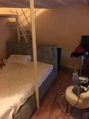 a bedroom with a bunk bed with a ladder at Teranga in Nice