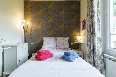 a bedroom with a bed with three towels on it at La Terrasse de Bracco in Beaulieu-sur-Mer