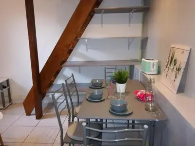 a kitchen with a table with four chairs at Charmant studio Nice in Nice