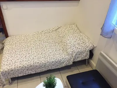 a bed in a small room with a pillow at Charmant studio Nice in Nice