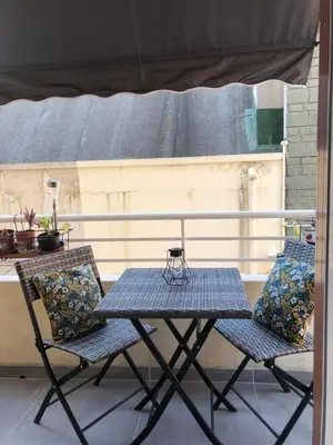 two chairs and a table on a patio at Le St Lambert, Grand Studio Libération in Nice