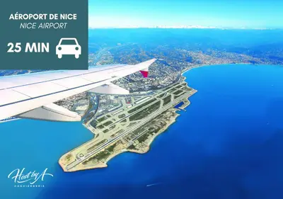 a wing of an airplane flying over a city at Green Hill Appartement à Nice Terrasse 130m2, Vue panoramique, Piscine, Parking Privé, Climatisation, WiFi in Nice