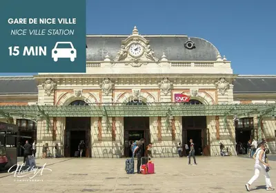 a large building with people walking in front of it at Green Hill Appartement à Nice Terrasse 130m2, Vue panoramique, Piscine, Parking Privé, Climatisation, WiFi in Nice
