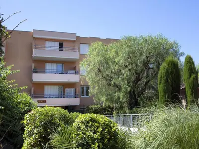 an apartment building with trees in front of it at Studio Le Bali by Interhome in Cagnes-sur-Mer