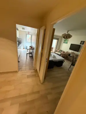 a bedroom with a large white bed with two slippers at Cosy appartement, terrasse in Nice
