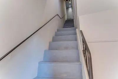 a staircase in a building with blue steps at AUTHENTIC VILLEFRANCHE AP4472 By Riviera Holiday Homes in Villefranche-sur-Mer
