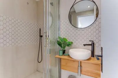 a bathroom with a shower and a sink and a mirror at AUTHENTIC VILLEFRANCHE AP4472 By Riviera Holiday Homes in Villefranche-sur-Mer