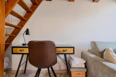 a desk with a chair next to a couch at Antibes Centre 2 pièces cosy proche remparts in Nice