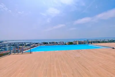a large swimming pool on the roof of a building at Seafront apartment with pool and comfort in Saint-Laurent-du-Var