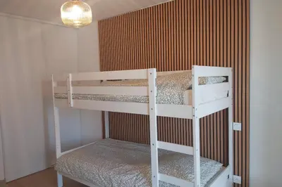 a couple of bunk beds in a room at Seafront apartment with pool and comfort in Saint-Laurent-du-Var